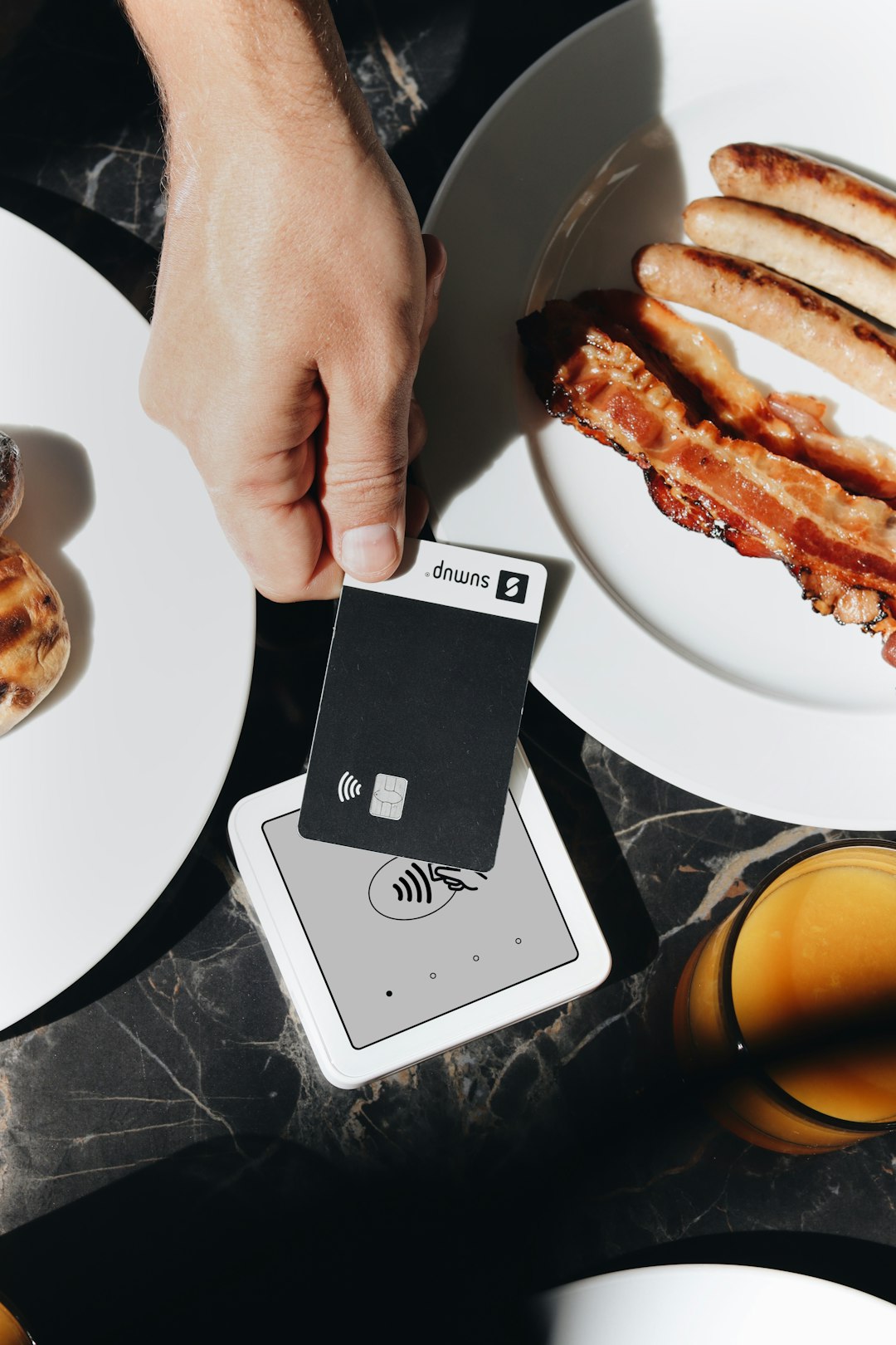 A SumUp card reader is placed on a table, ready to accept contactless payments. The setup is ideal for small businesses and cafés, offering a sleek and efficient way for entrepreneurs to accept payments.